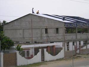 The roof goes up on the  church.  July 2007